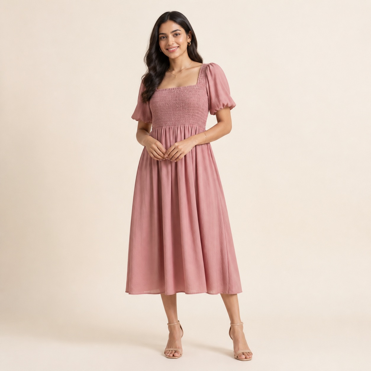 Young Indian woman in a dusty rose midi dress